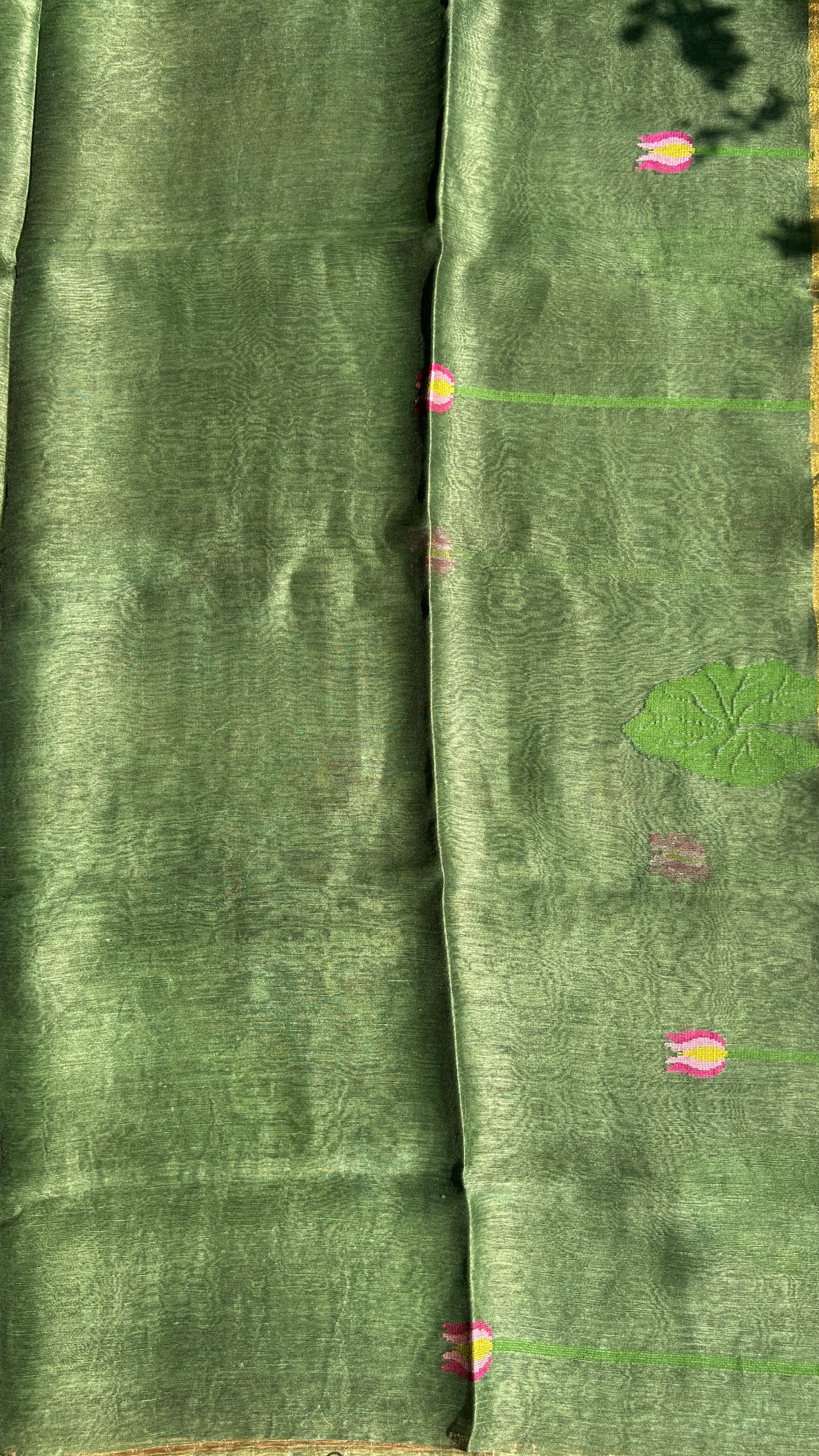 Green silk linen jamdani saree with lotus motifs